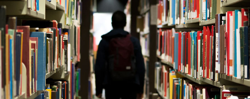 A student walking through the library